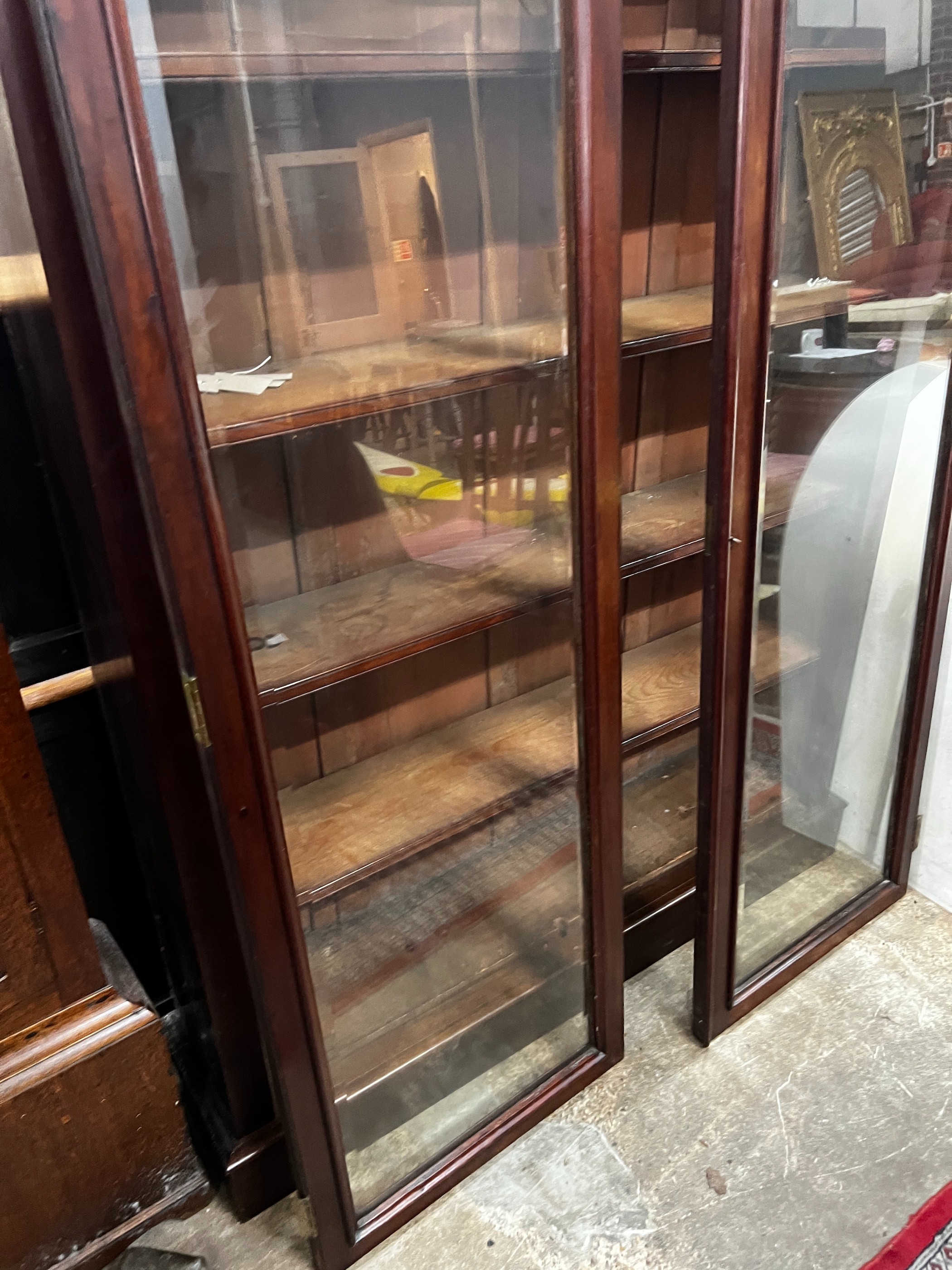 A large mahogany bookcase with two glazed panel doors, width 138cm, depth 31cm, height 209cm